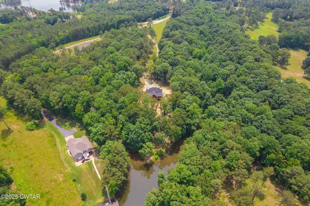 a backyard of a house with a yard and lake view