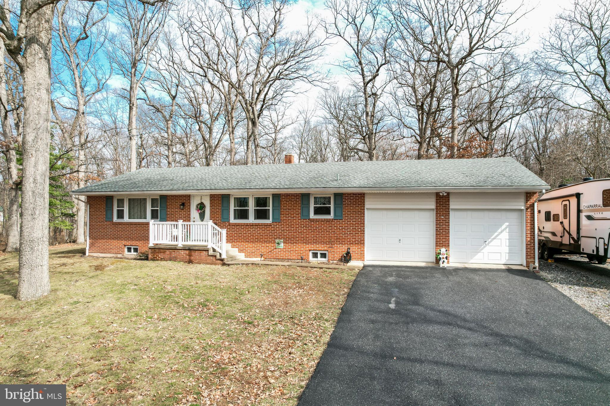 3820 Kump Station Road Taneytown, MD 21787 - Photo 1 of 59 a front view of a house with a yard and seating space