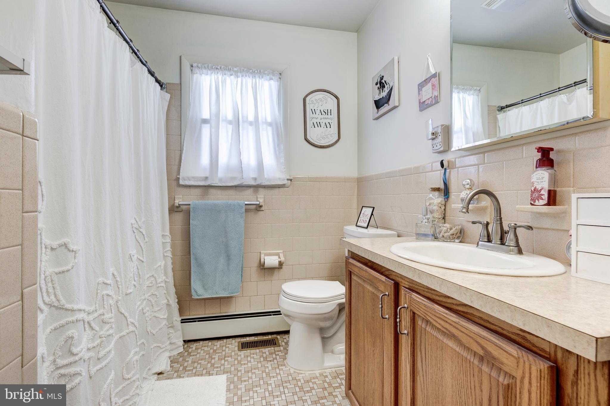 3820 Kump Station Road Taneytown, MD 21787 - Photo 19 of 59 a bathroom with a sink a toilet and a mirror