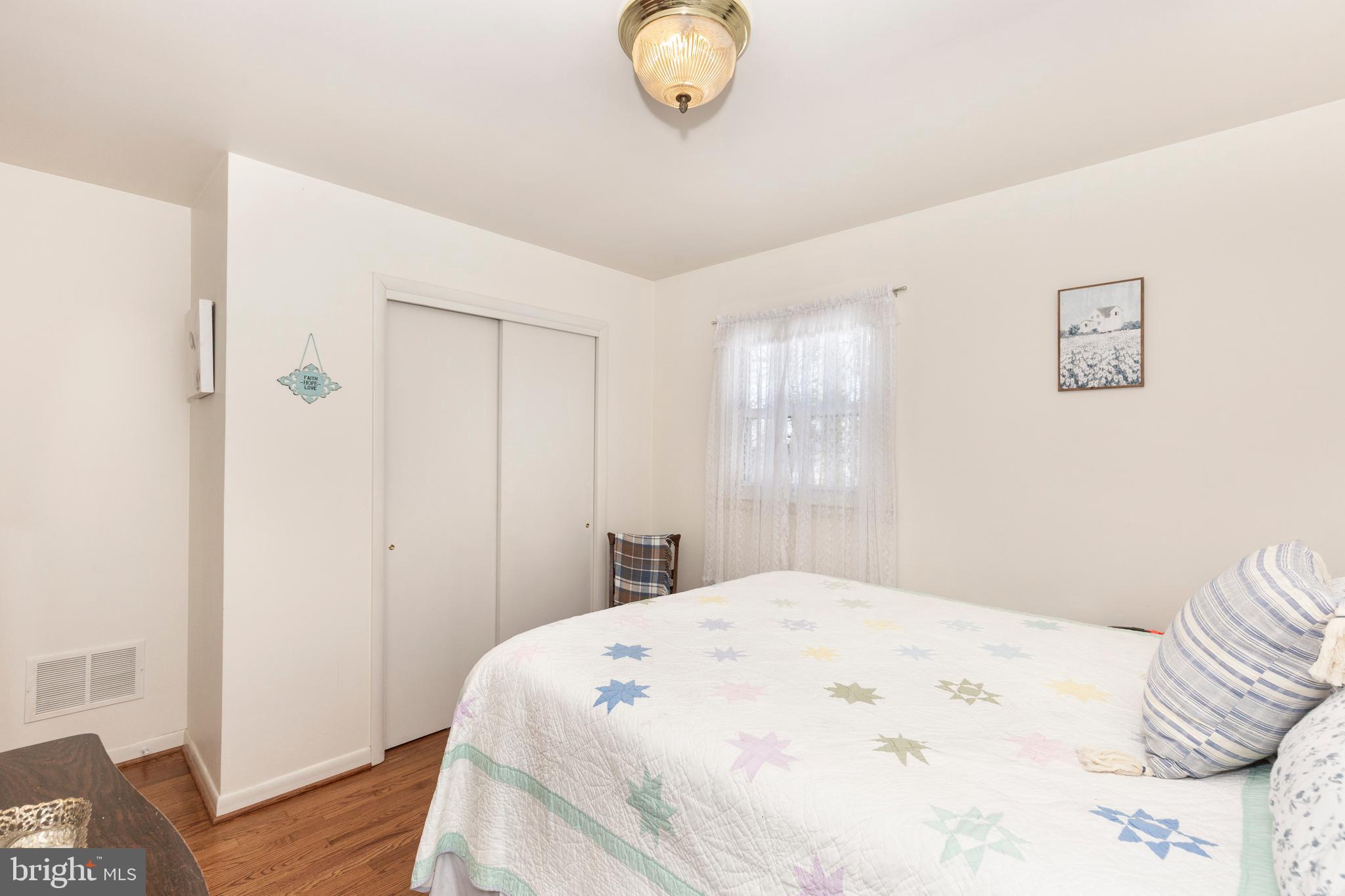 3820 Kump Station Road Taneytown, MD 21787 - Photo 23 of 59 a bedroom with a bed and wooden floor