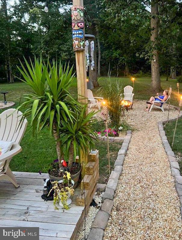 3820 Kump Station Road Taneytown, MD 21787 - Photo 29 of 59 a view of a lake with a table and chairs and potted plants