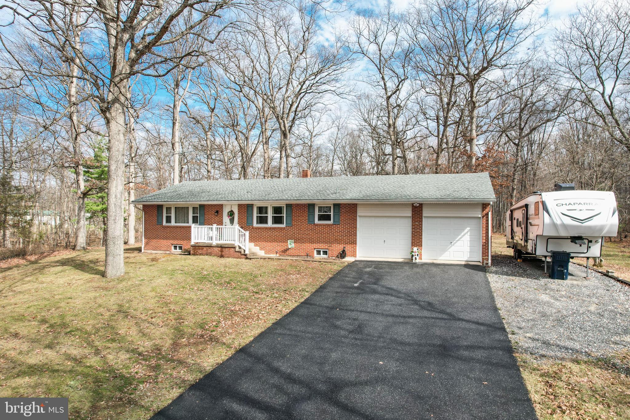 3820 Kump Station Road Taneytown, MD 21787 - Photo 34 of 59 a front view of a house with a yard outdoor seating and covered with trees
