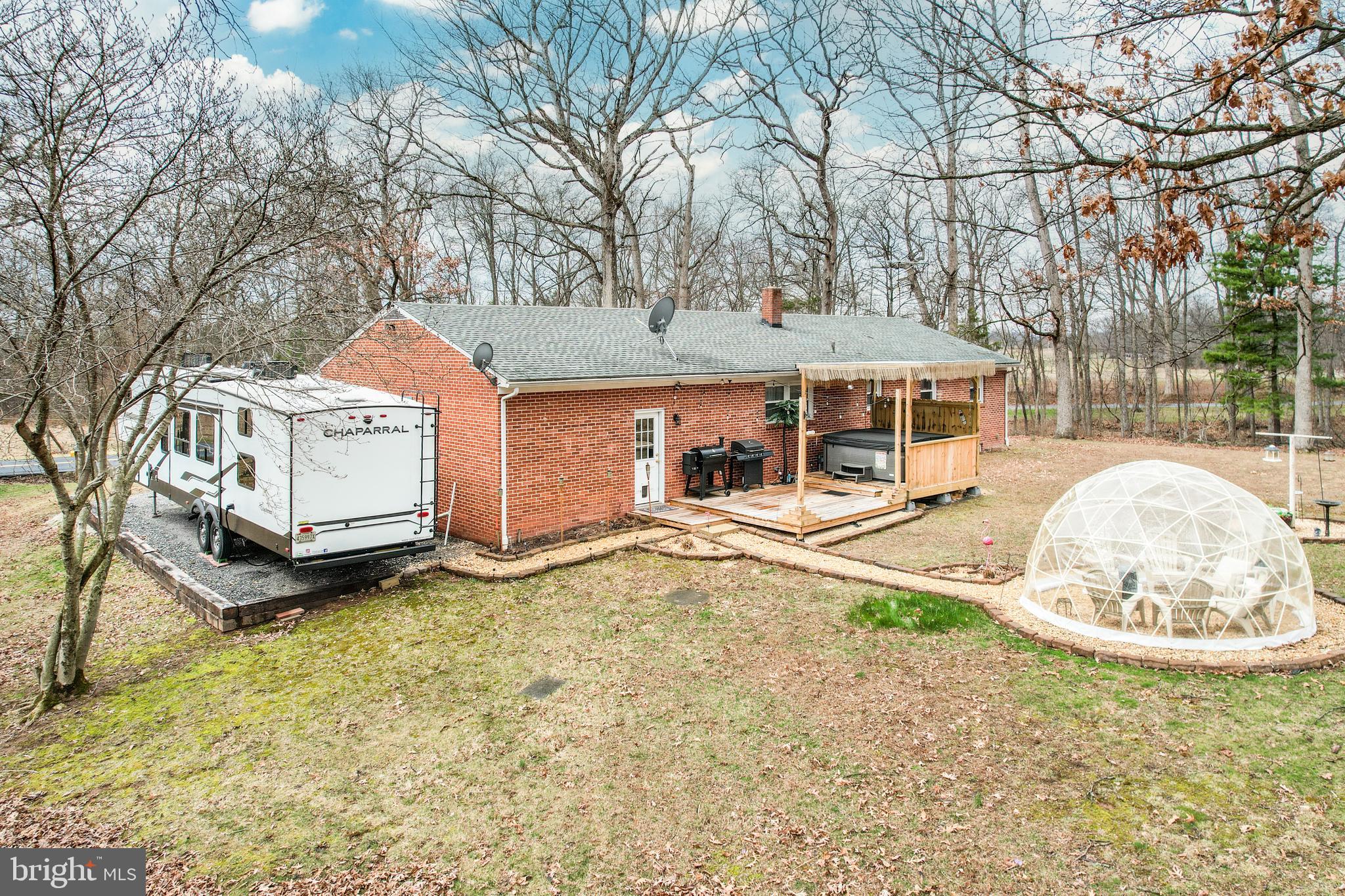 3820 Kump Station Road Taneytown, MD 21787 - Photo 44 of 59 a view of a white house with a yard and sitting area