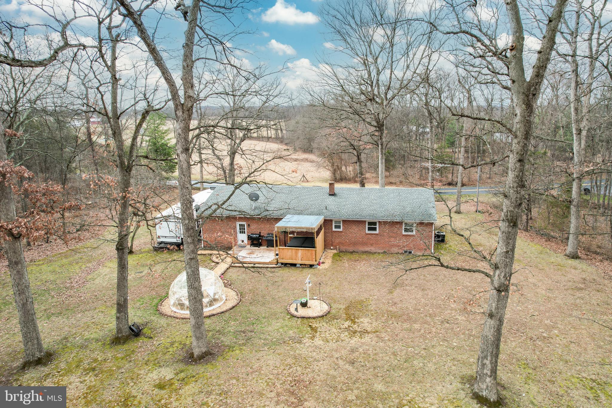 3820 Kump Station Road Taneytown, MD 21787 - Photo 45 of 59 a backyard of a house with barbeque oven and wooden fence