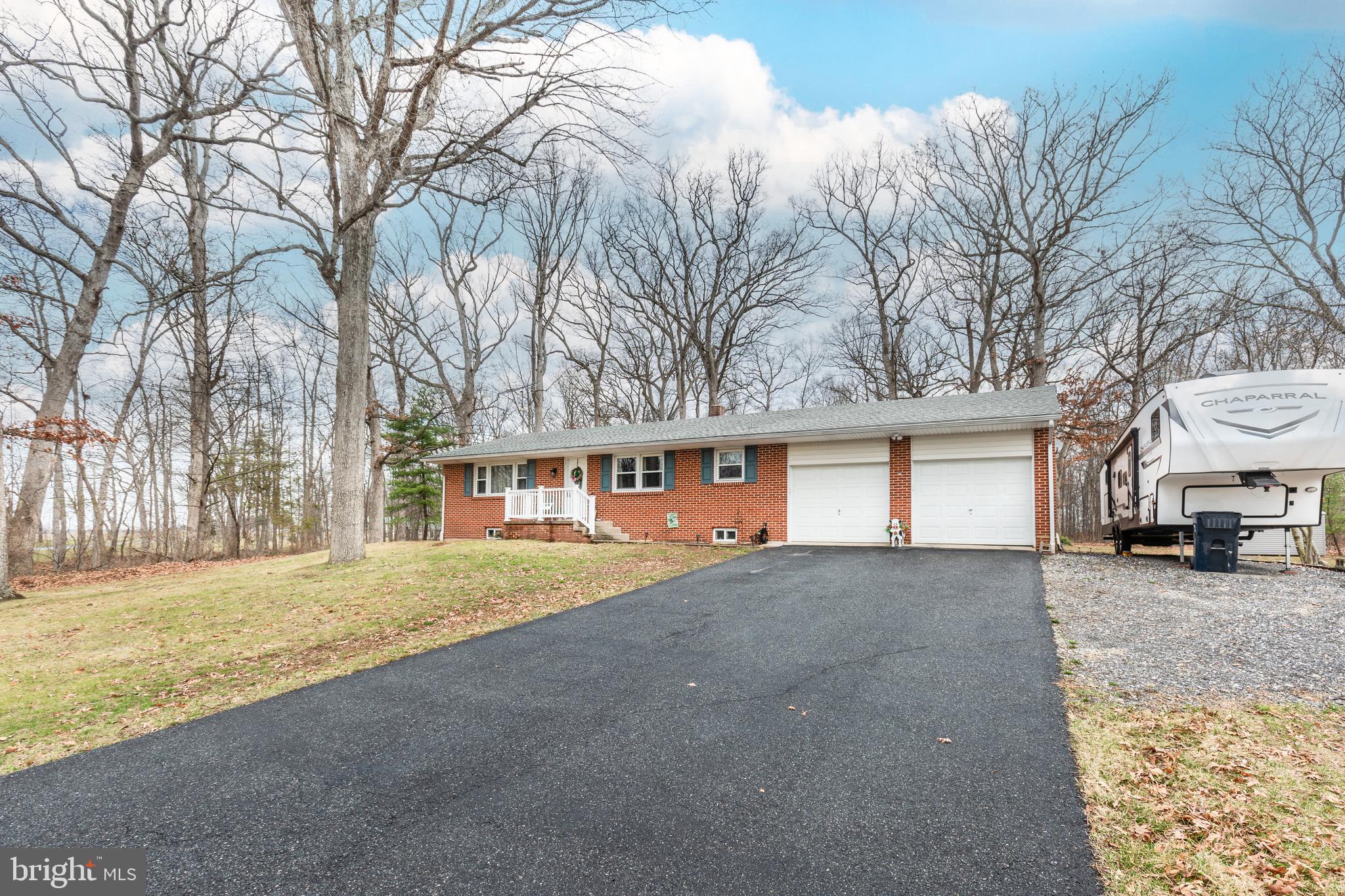 3820 Kump Station Road Taneytown, MD 21787 - Photo 46 of 59 a front view of a house with a yard and garage