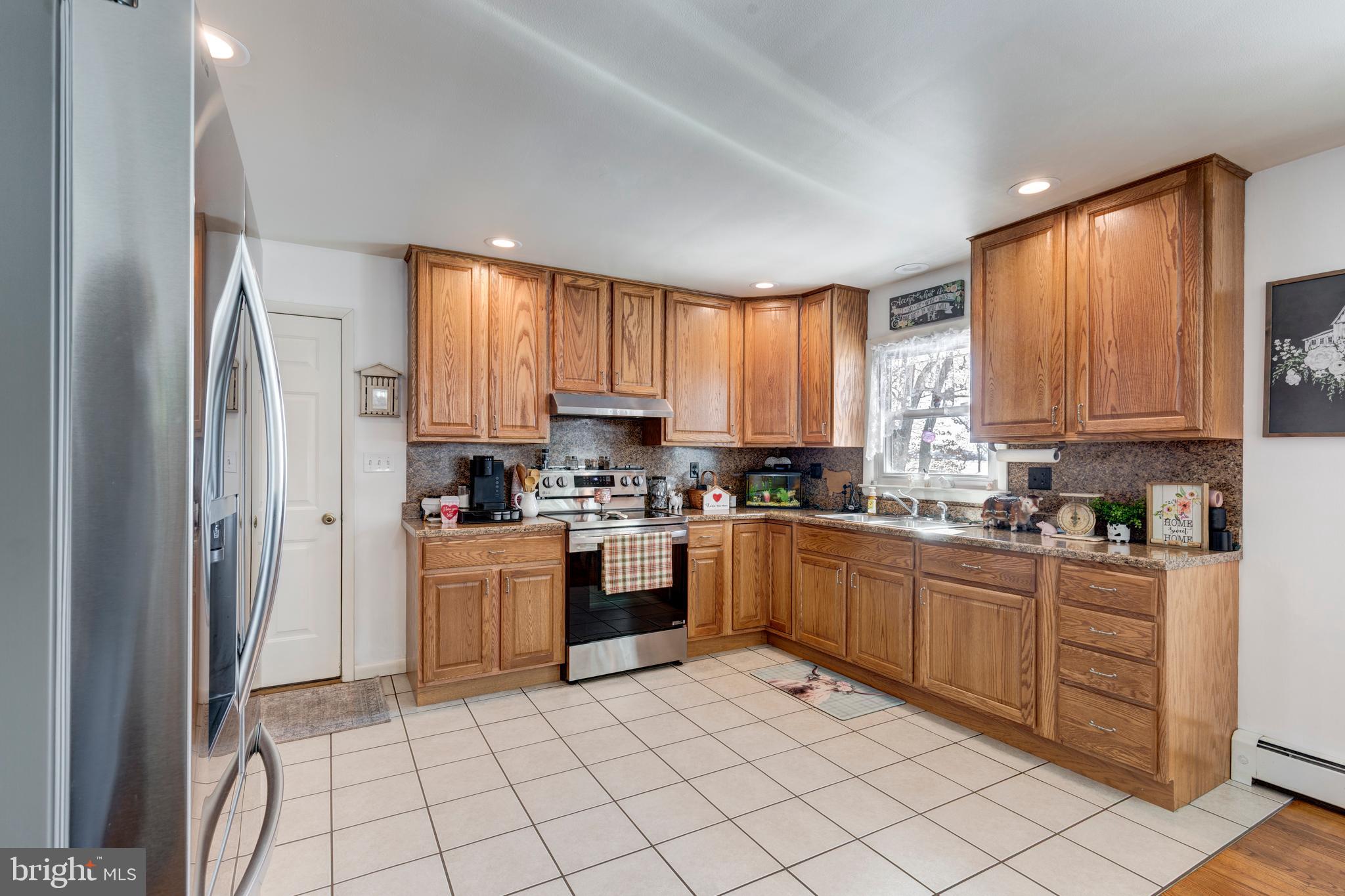 3820 Kump Station Road Taneytown, MD 21787 - Photo 5 of 59 a kitchen with stainless steel appliances granite countertop a refrigerator sink and cabinets