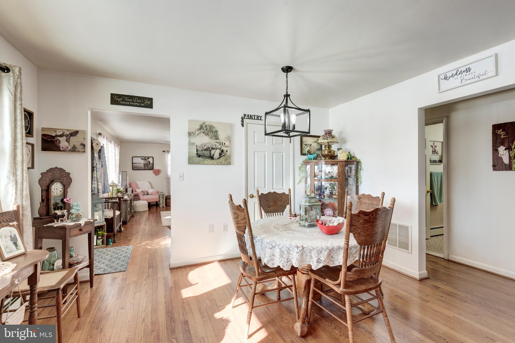 3820 Kump Station Road Taneytown, MD 21787 - Photo 7 of 59 a view of a dining room with furniture wooden floor and chandelier