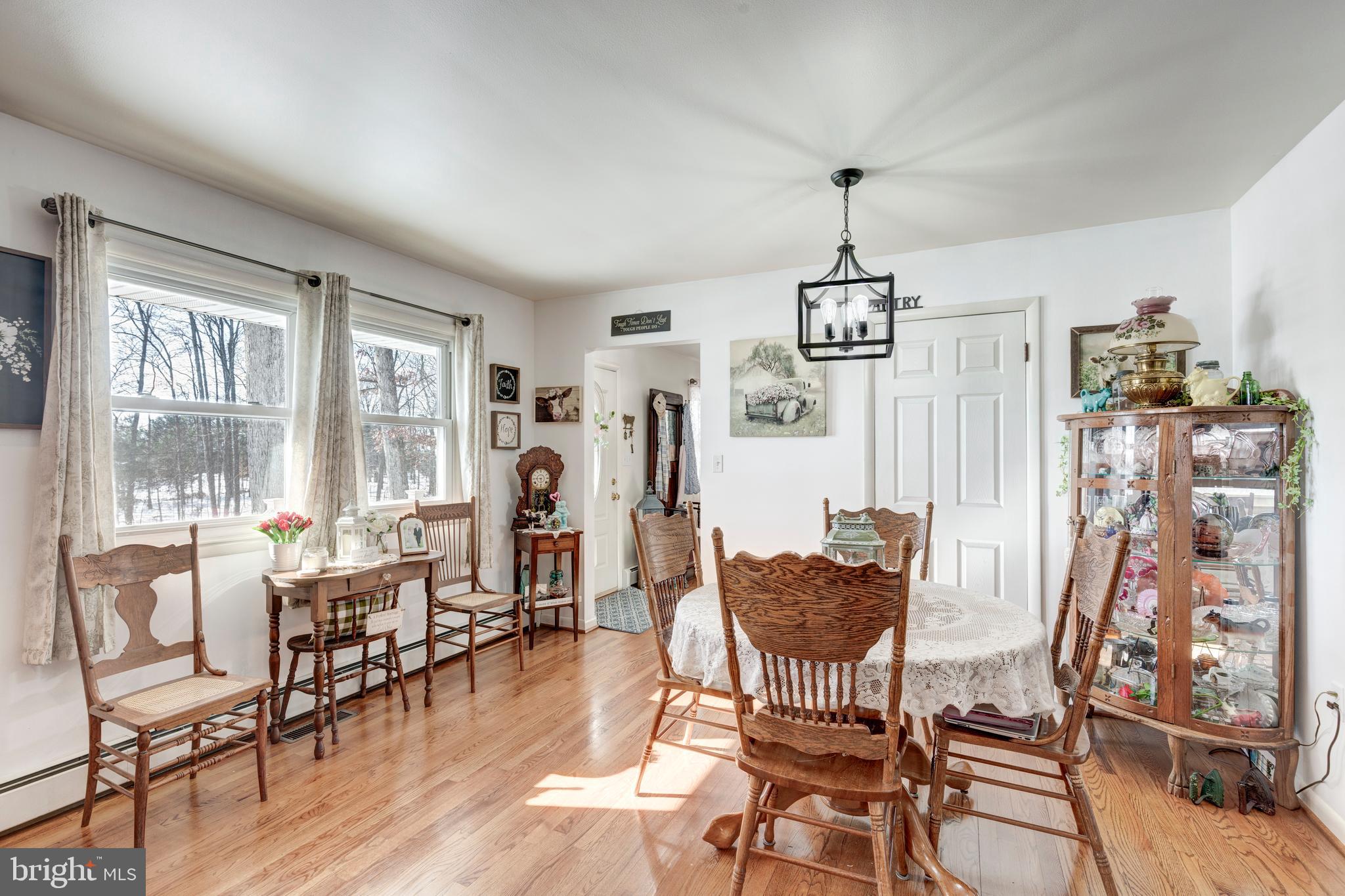 3820 Kump Station Road Taneytown, MD 21787 - Photo 9 of 59 a living room with furniture a dining table and a large window