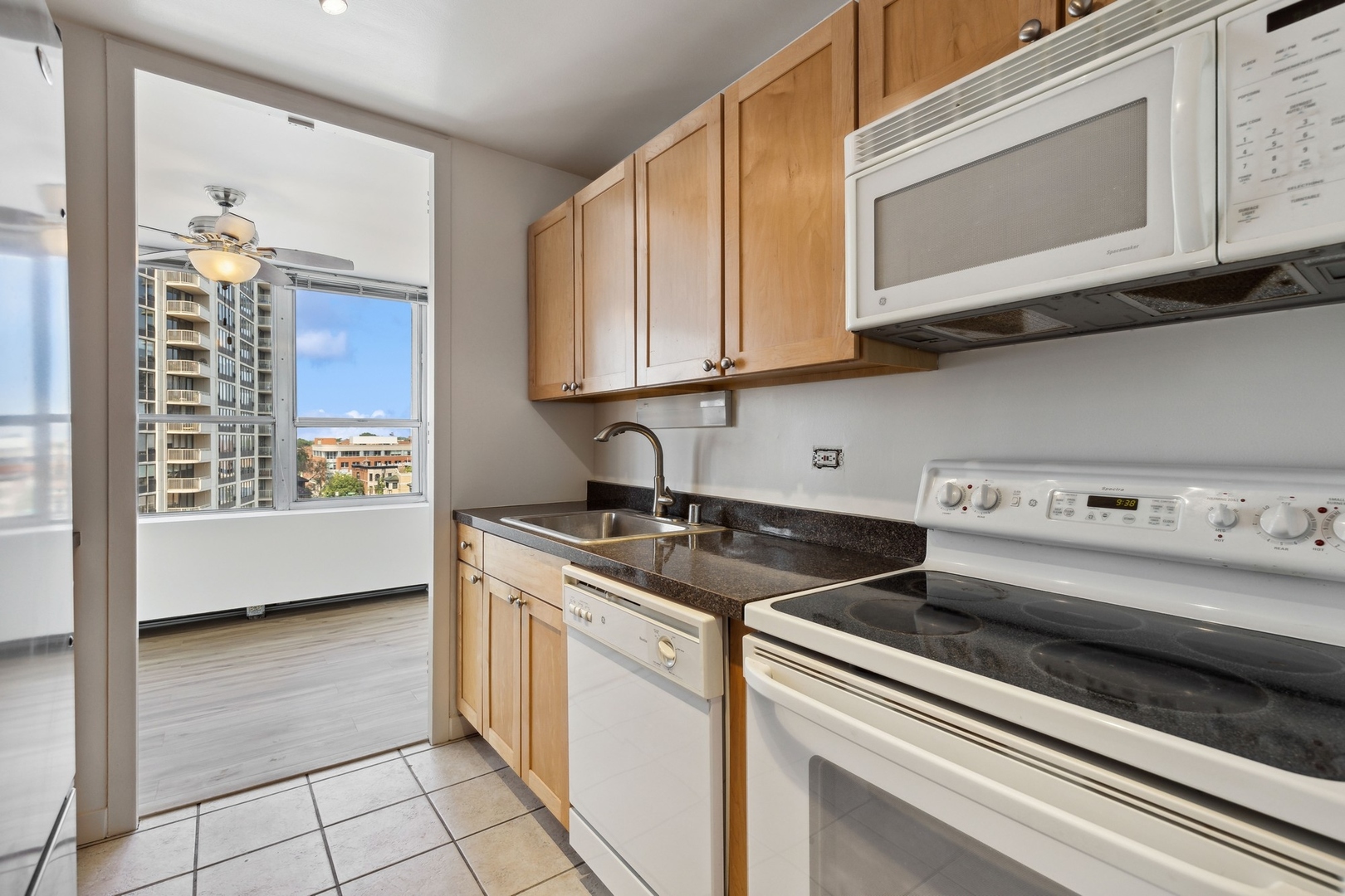 655 West Irving Park Road, Unit 617 Chicago, IL 60613 - Photo 13 of 33 a kitchen with stainless steel appliances granite countertop a sink and a stove