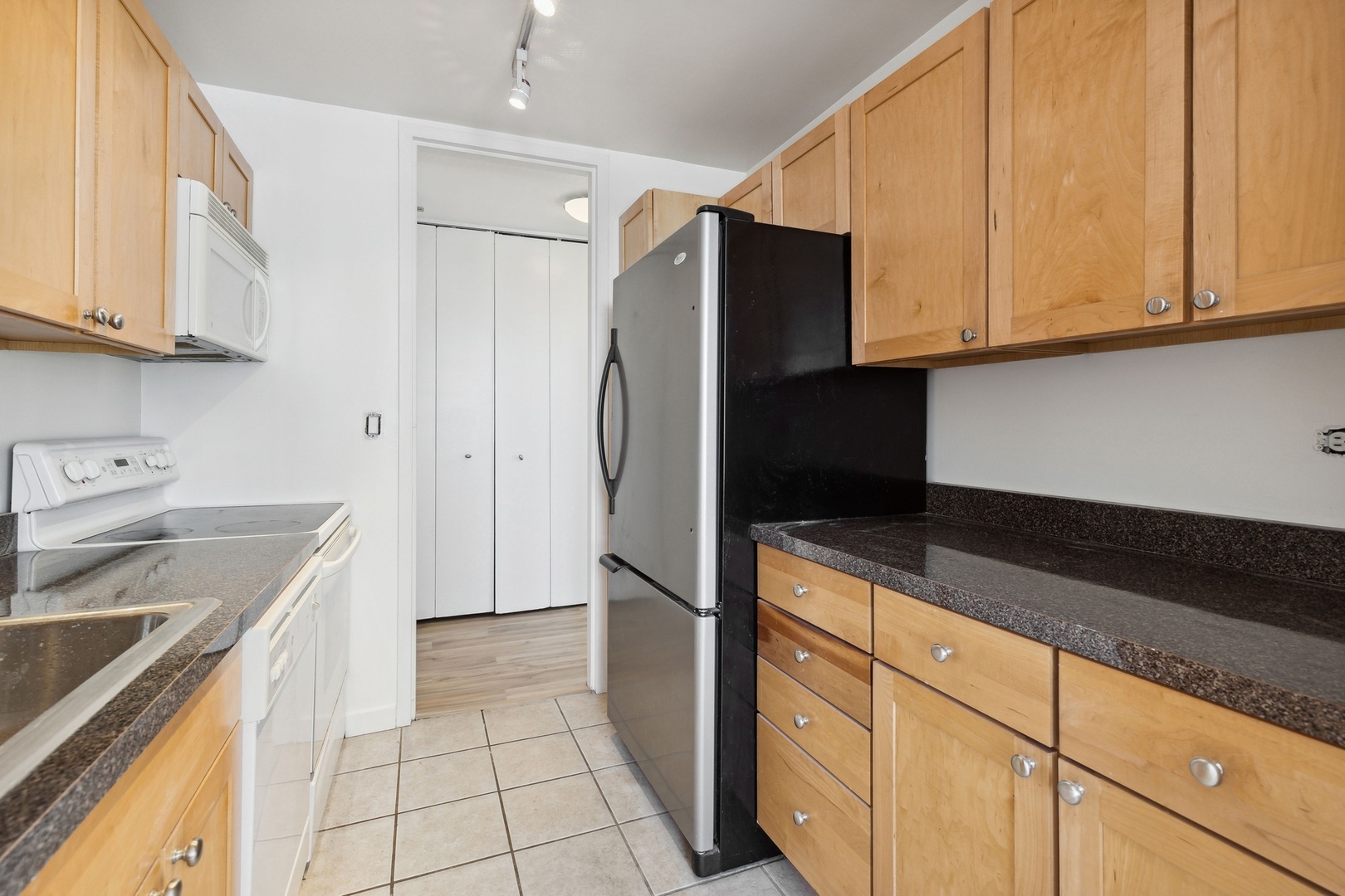 655 West Irving Park Road, Unit 617 Chicago, IL 60613 - Photo 14 of 33 a kitchen with stainless steel appliances granite countertop a refrigerator sink and cabinets