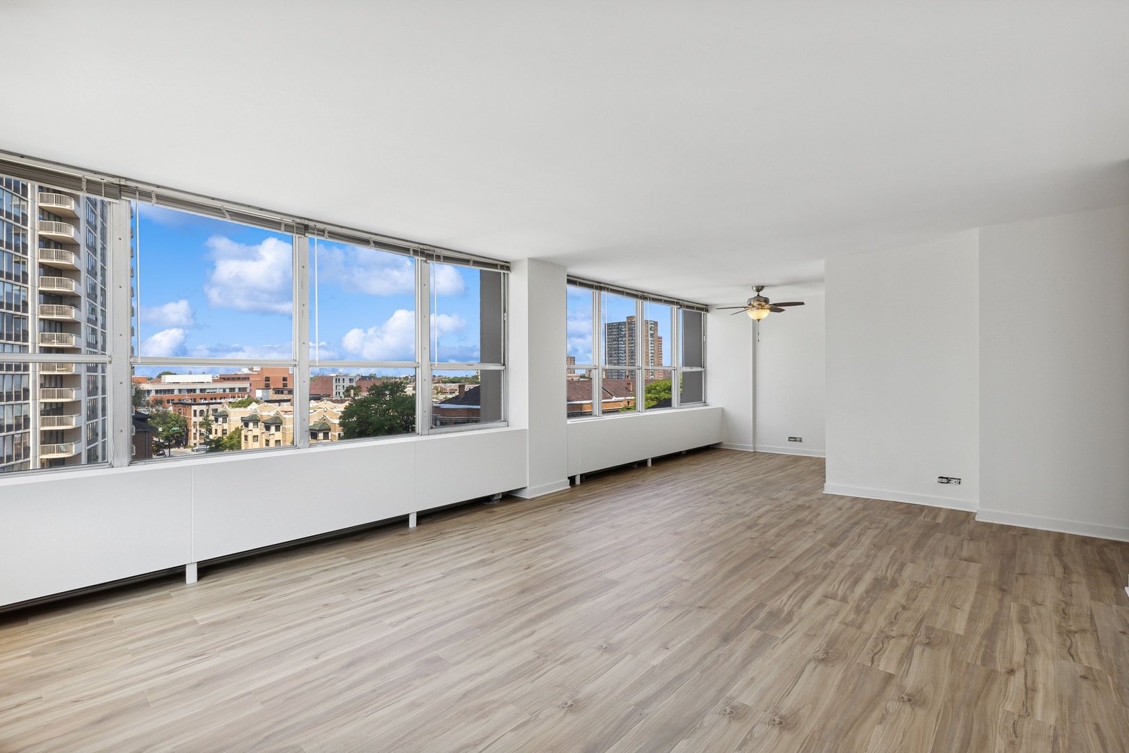 655 West Irving Park Road, Unit 617 Chicago, IL 60613 - Photo 4 of 33 an empty room with wooden floor and windows