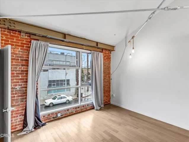 a view of a room with wooden floor and windows
