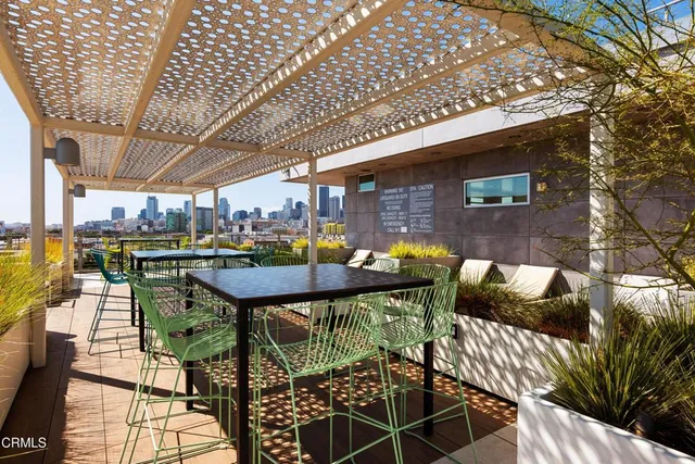 a view of a patio with table and chairs with wooden floor and fence