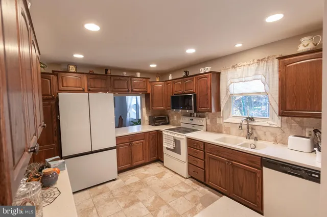 a kitchen with refrigerator and sink