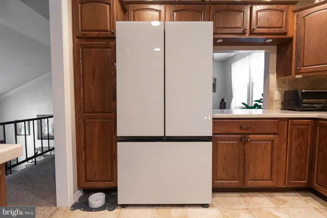 a kitchen with a refrigerator and cabinets