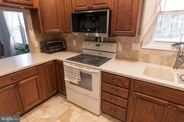 a kitchen with a sink stove and microwave