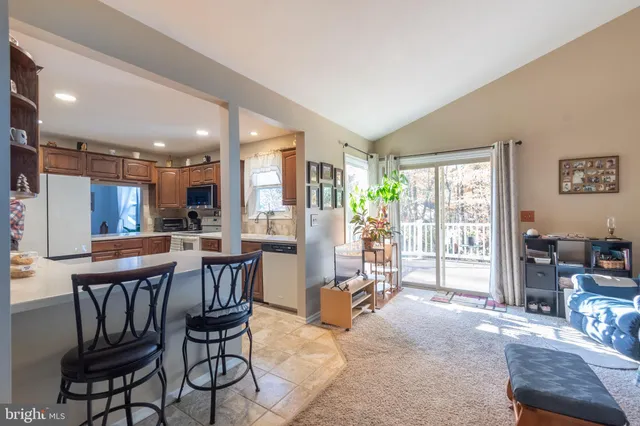 a dining room with furniture and large windows