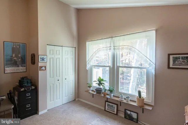 a living room with furniture and large windows