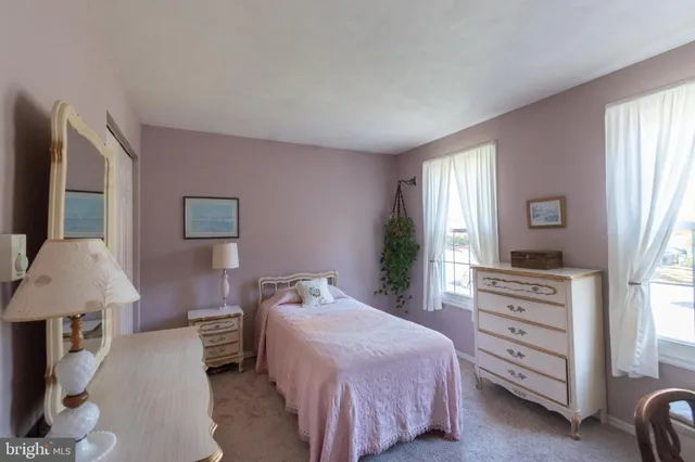 a spacious bedroom with a bed and a window