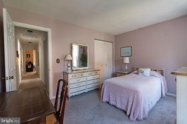 a bedroom with a bed and a dresser