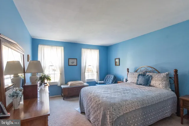 a bedroom with a bed and lamp chandelier