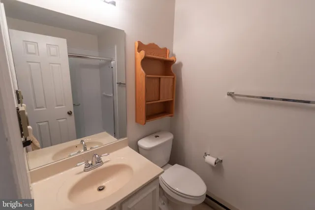 a bathroom with a toilet sink and mirror
