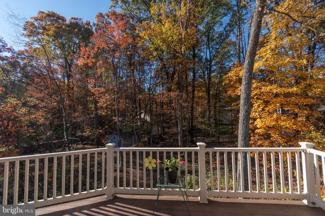 a view of balcony with wooden floor and fence