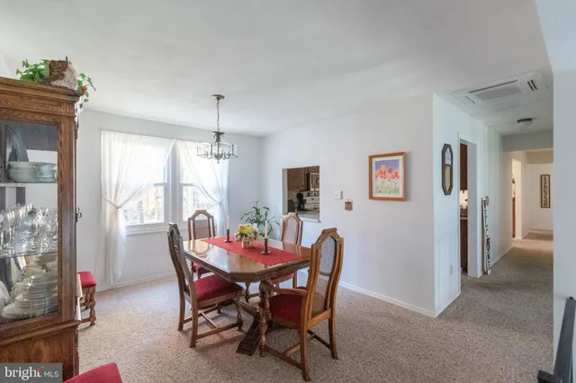 a view of a dining room with furniture and a chandelier