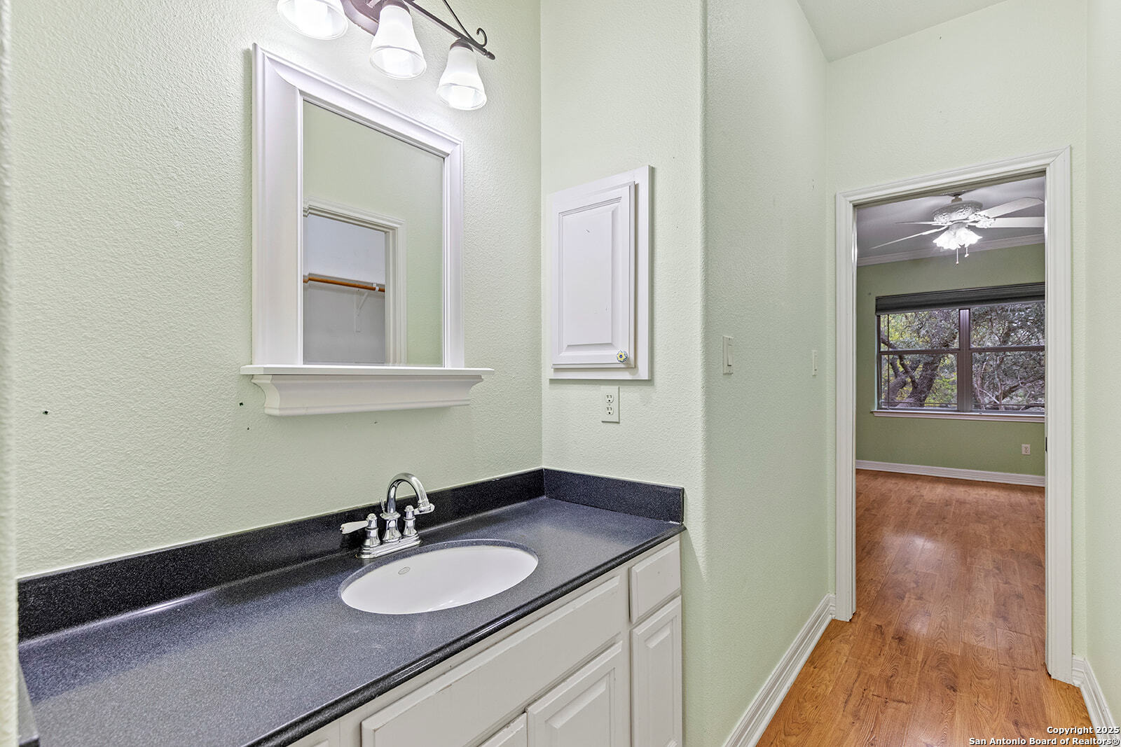 632 Copper Rim Spring Branch, TX 78070 - Photo 31 of 45 a bathroom with a granite countertop sink and a mirror