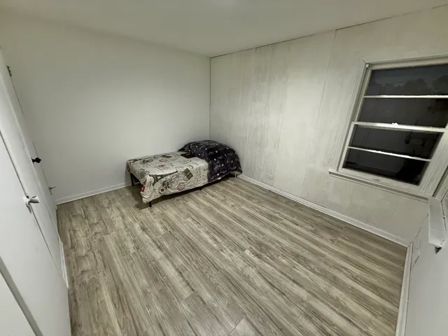a room with a bed and cabinets