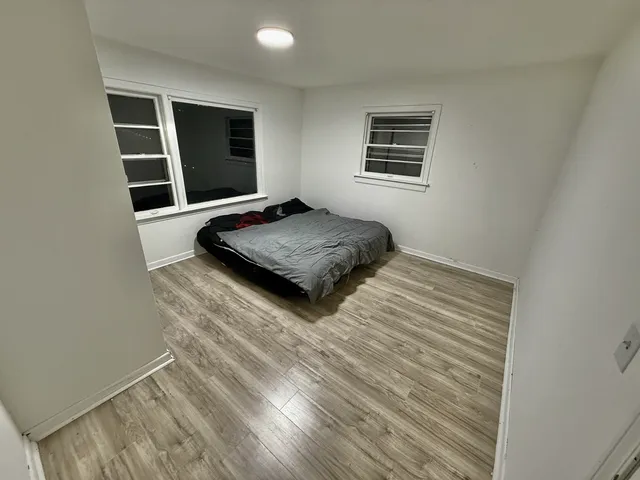 a bedroom with bed and flat screen tv
