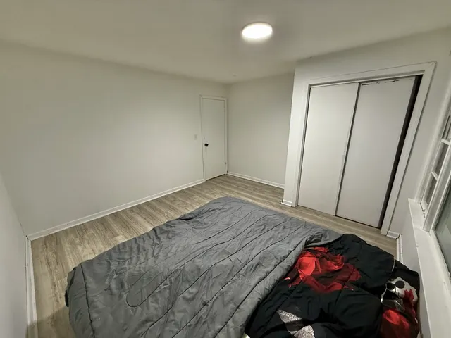 a view of a room with wooden floor and closet