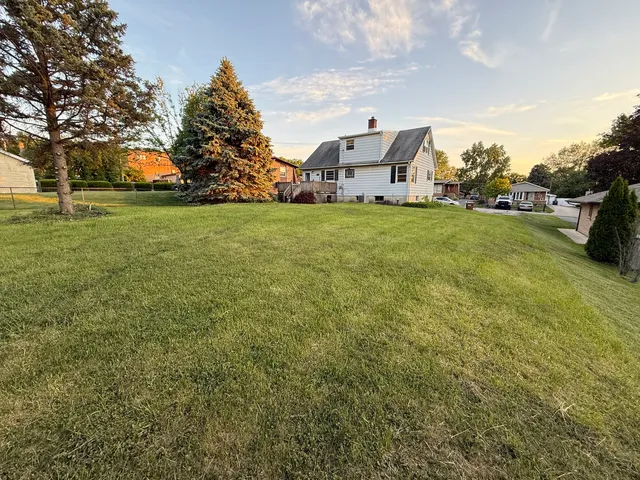 a aerial view of a house with a yard and garage