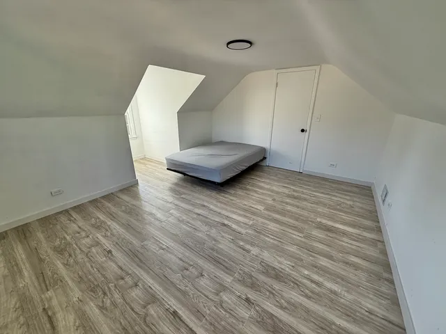 a view of a room with wooden floor