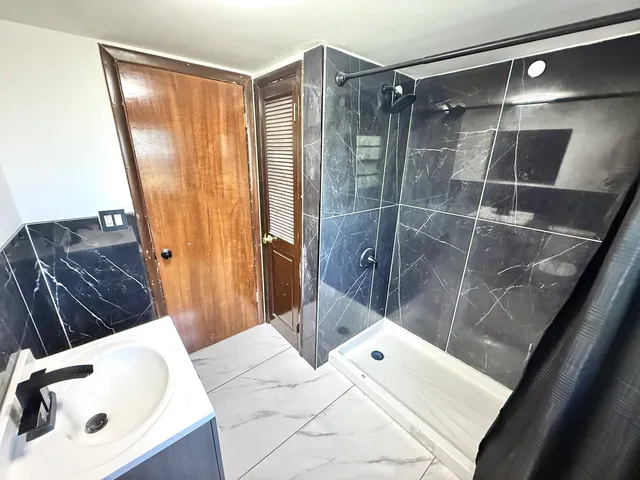 a bathroom with a tub and shower