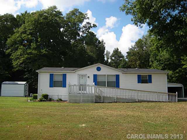3915 Berry Hill Road Edgemoor, SC 29712 - Photo 1 of 16 a front view of a house with a garden