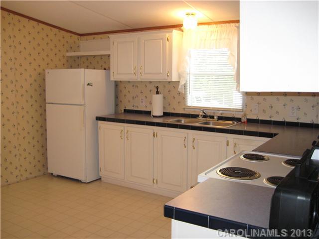 3915 Berry Hill Road Edgemoor, SC 29712 - Photo 6 of 16 a kitchen with a sink a stove and a refrigerator