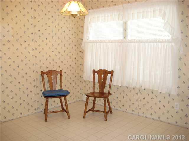 3915 Berry Hill Road Edgemoor, SC 29712 - Photo 8 of 16 a bathroom with a toilet and a chair