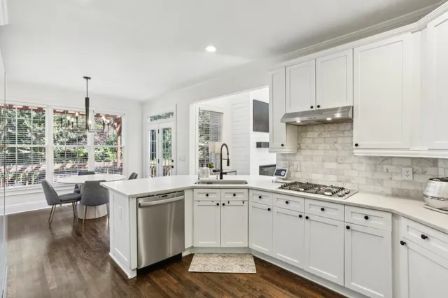 a kitchen with a sink stove and cabinets