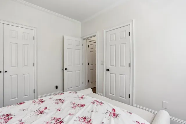 a bedroom with a bed and hallway