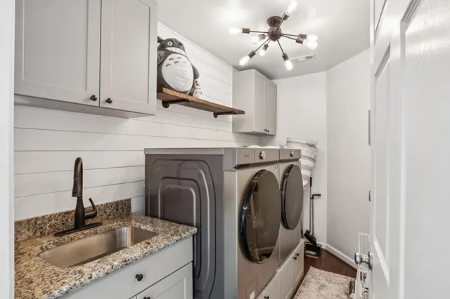 a kitchen with a sink a stove and a granite counter top