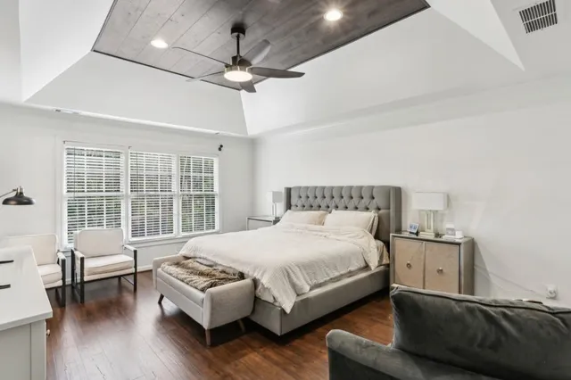 a bedroom with a bed window and a couch