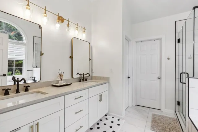 a bathroom with double sink and a mirror