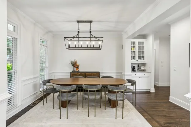 a view of a dining room with furniture a chandelier and wooden floor