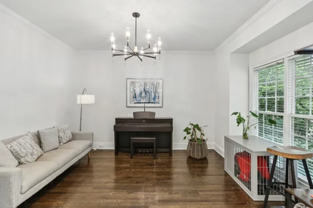 a living room with furniture and a chandelier