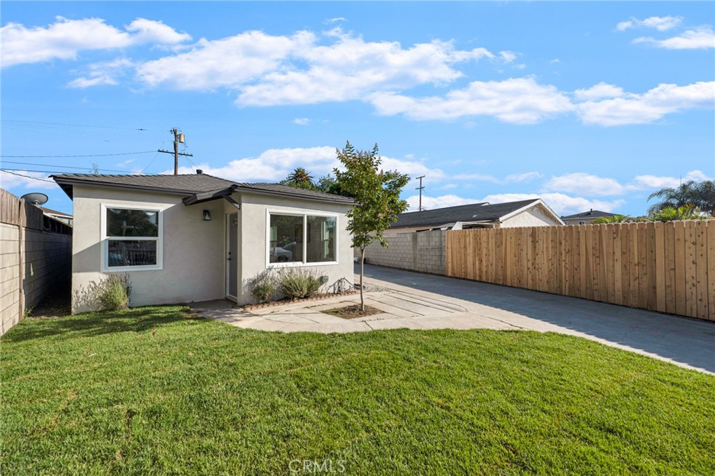 a backyard of a house with table and chairs
