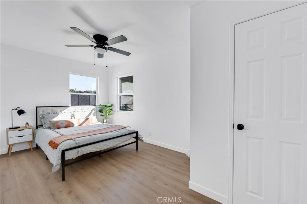 2124 East Oris Street Compton, CA 90222 - Photo 13 of 20 a spacious bedroom with a bed and a chandelier