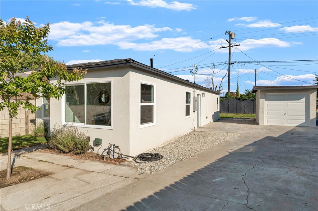 2124 East Oris Street Compton, CA 90222 - Photo 14 of 20 a front view of a house with a yard and garage