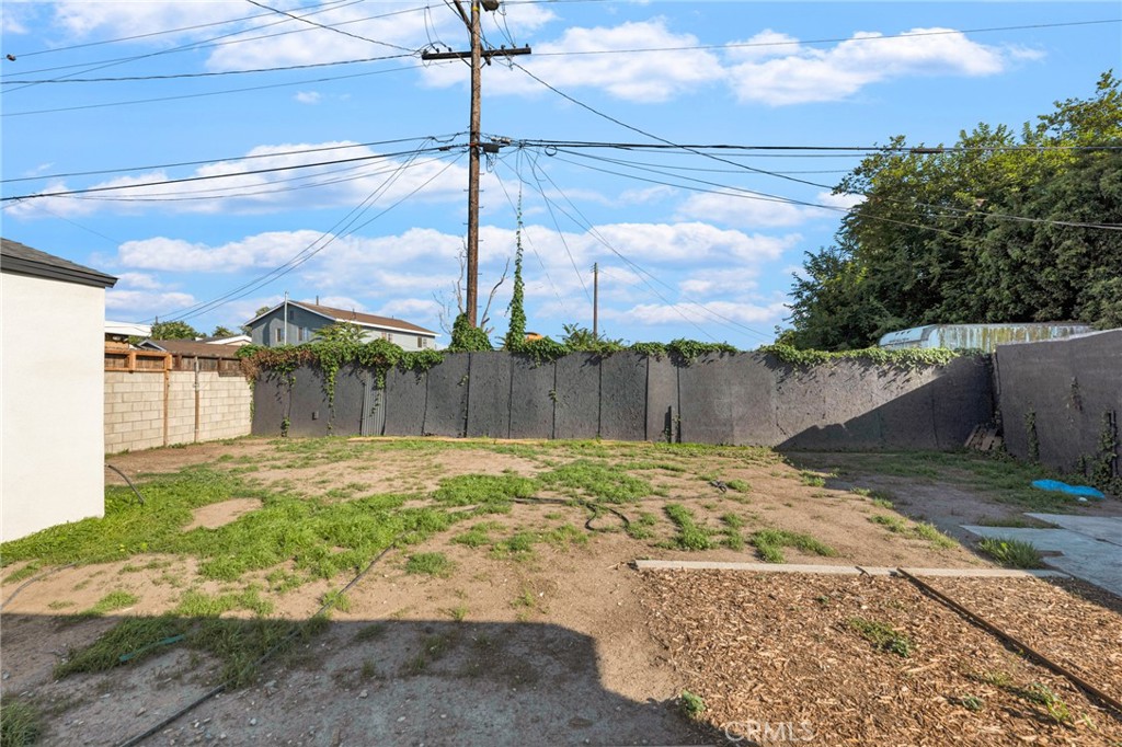 2124 East Oris Street Compton, CA 90222 - Photo 17 of 20 a small yard with trees in the background
