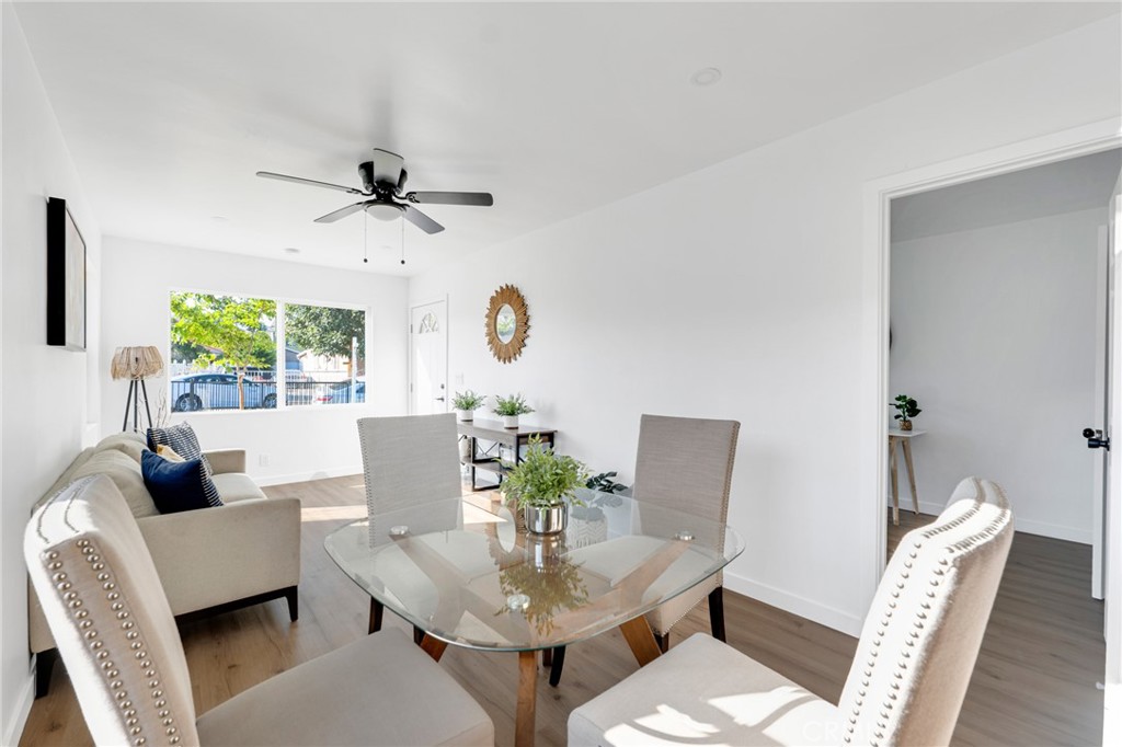 2124 East Oris Street Compton, CA 90222 - Photo 4 of 20 a living room with furniture a chandelier and a window